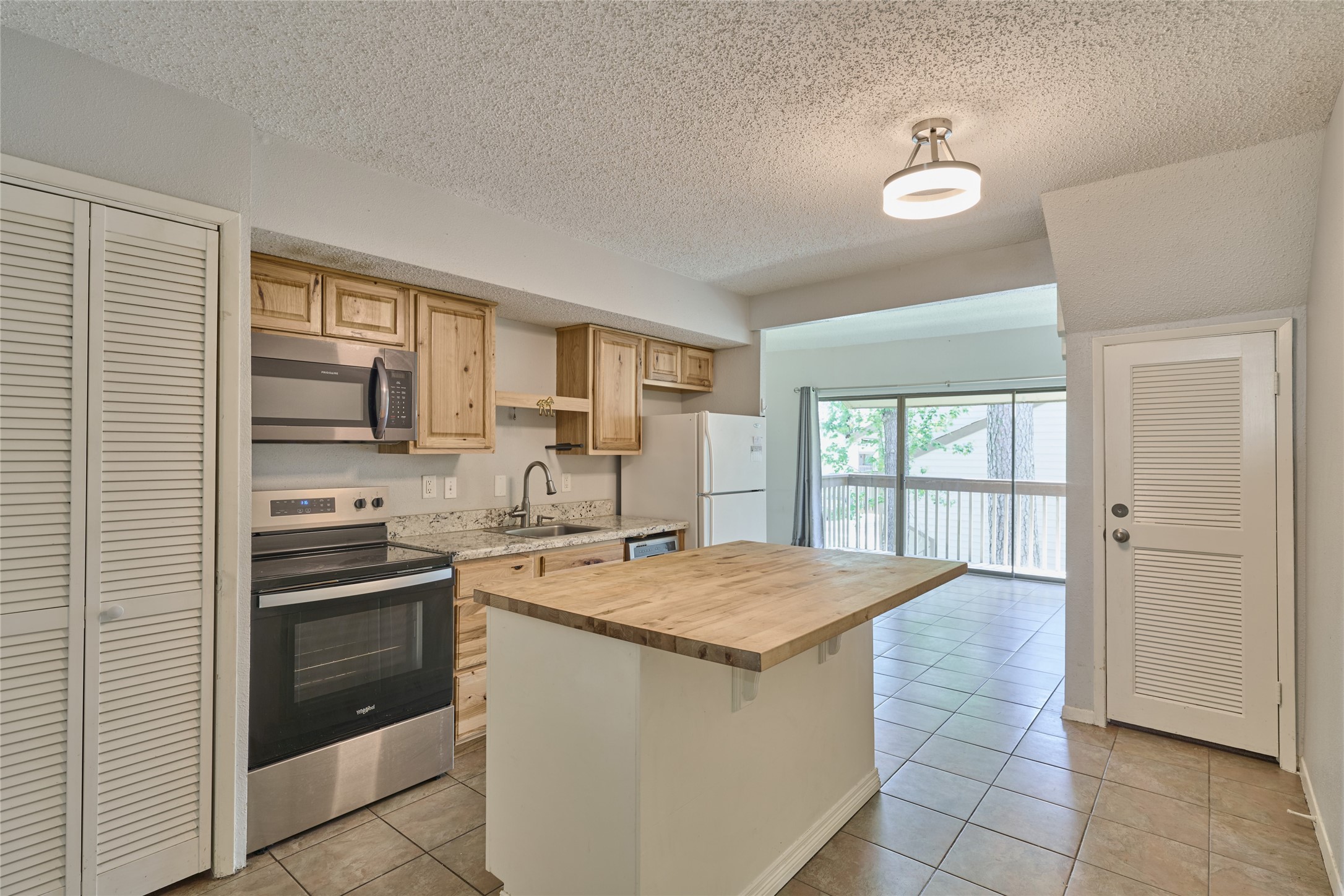 12900 Walden Road, Unit 622F Montgomery, TX 77356 - Photo 4 of 32 a kitchen that has a sink and stainless steel appliances