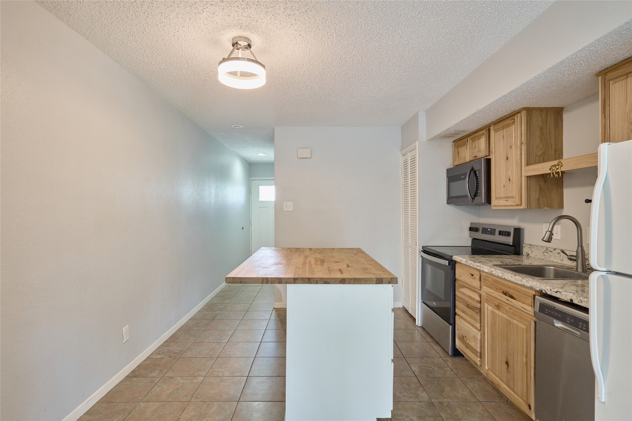 12900 Walden Road, Unit 622F Montgomery, TX 77356 - Photo 5 of 32 a kitchen with stainless steel appliances granite countertop a sink stove and refrigerator