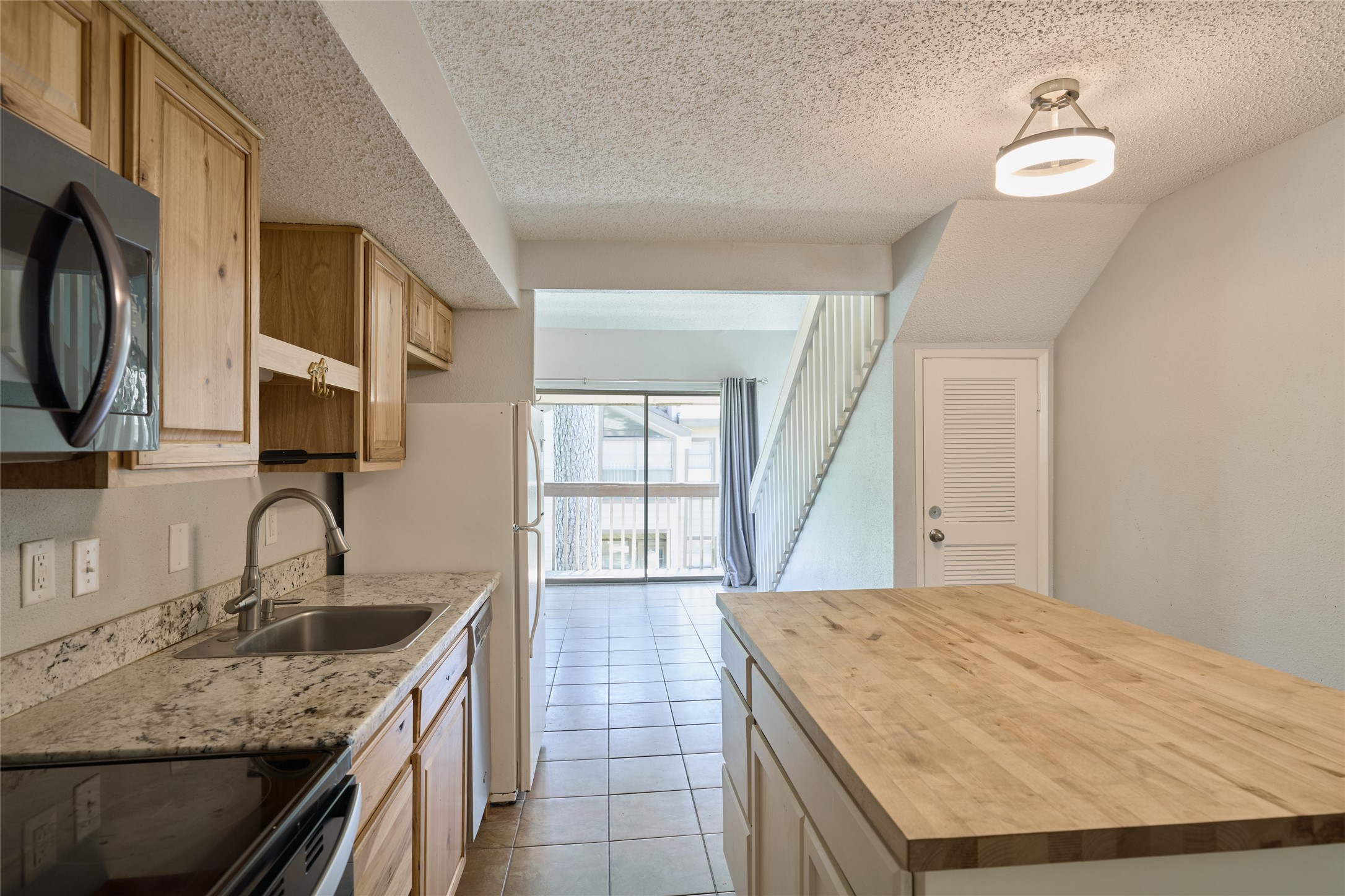 12900 Walden Road, Unit 622F Montgomery, TX 77356 - Photo 7 of 32 a kitchen with a sink a stove and cabinets