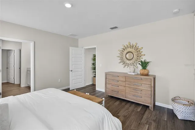 a bedroom with a bed and a dresser