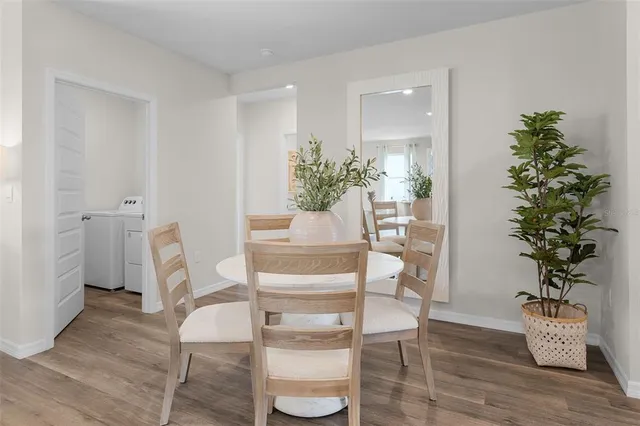a dining room with furniture and wooden floor