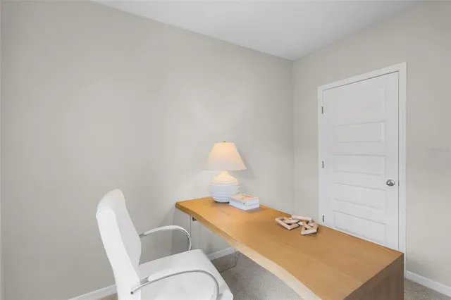 a workspace room with a table and chairs