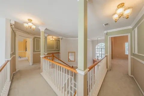 a view of a hallway view with staircase