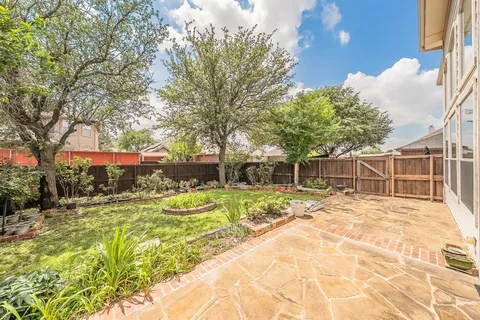 a view of a backyard with large trees