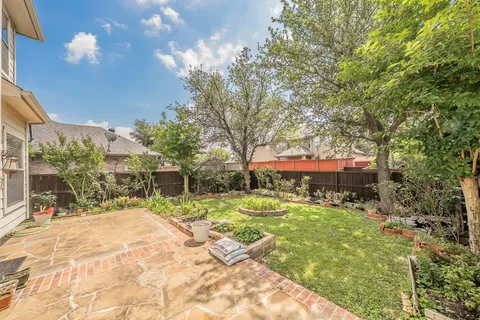 a view of a house with a yard and sitting area