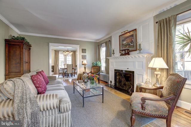 a living room with furniture fireplace and window