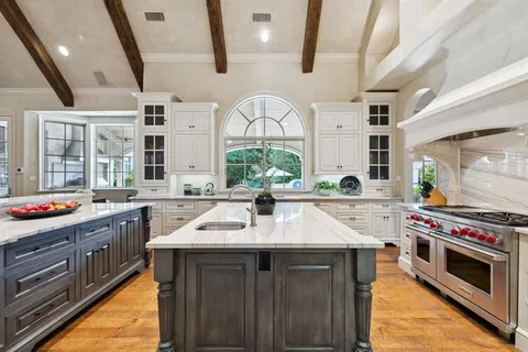 a kitchen with a sink stove and cabinets