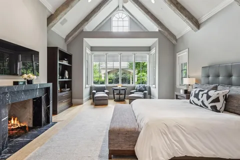 a bed room with a bed and a fireplace