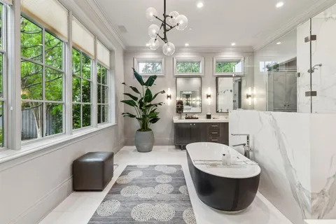 a bathroom with a bathtub sink and mirror