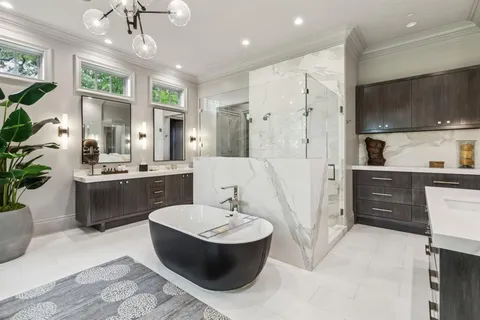 a large white kitchen with a large tub and sink
