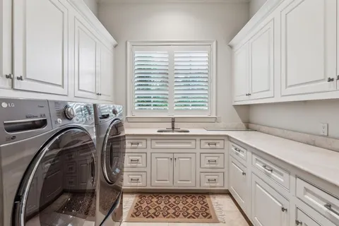 a kitchen with a sink stove and cabinets