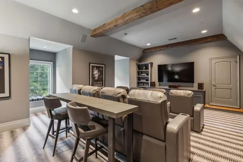 a view of a dining room with furniture and a flat screen tv