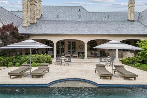 a view of a patio with table and chairs under an umbrella