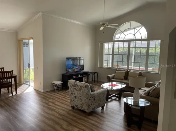 a living room with furniture a fireplace and a large window