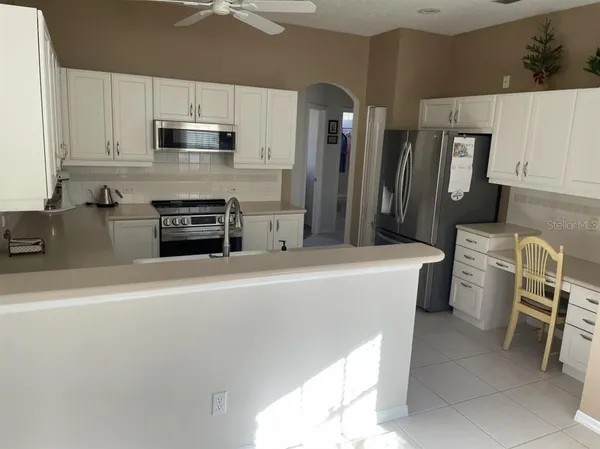 a kitchen with stainless steel appliances a refrigerator stove microwave and sink