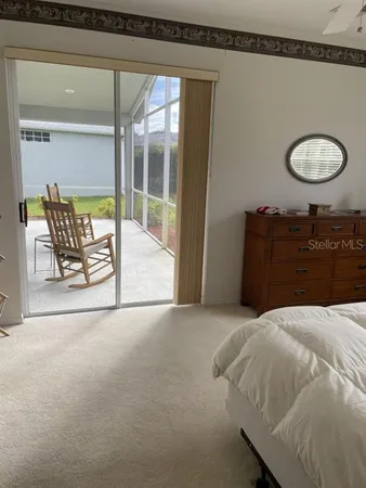 a bedroom with a bed and painting on the wall