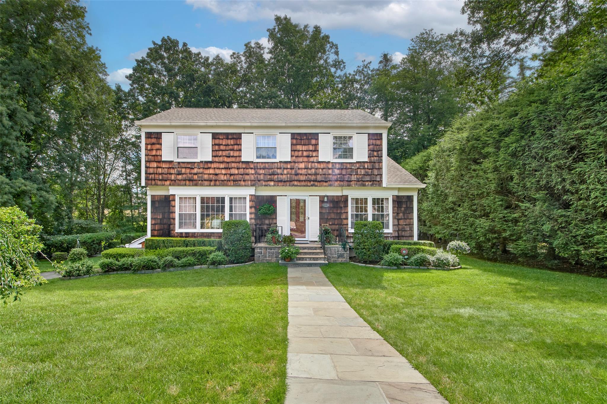 a front view of house with yard and green space
