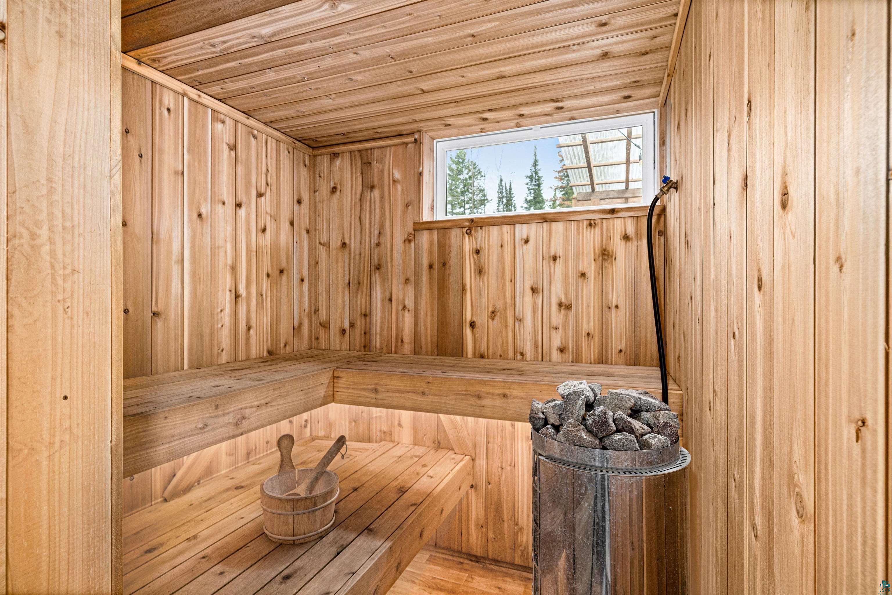 1825 East Shilhon Road Duluth, MN 55804 - Photo 22 of 37 Therapeutic & spacious cedar-paneled sauna w a built-in window and sauna heater.
