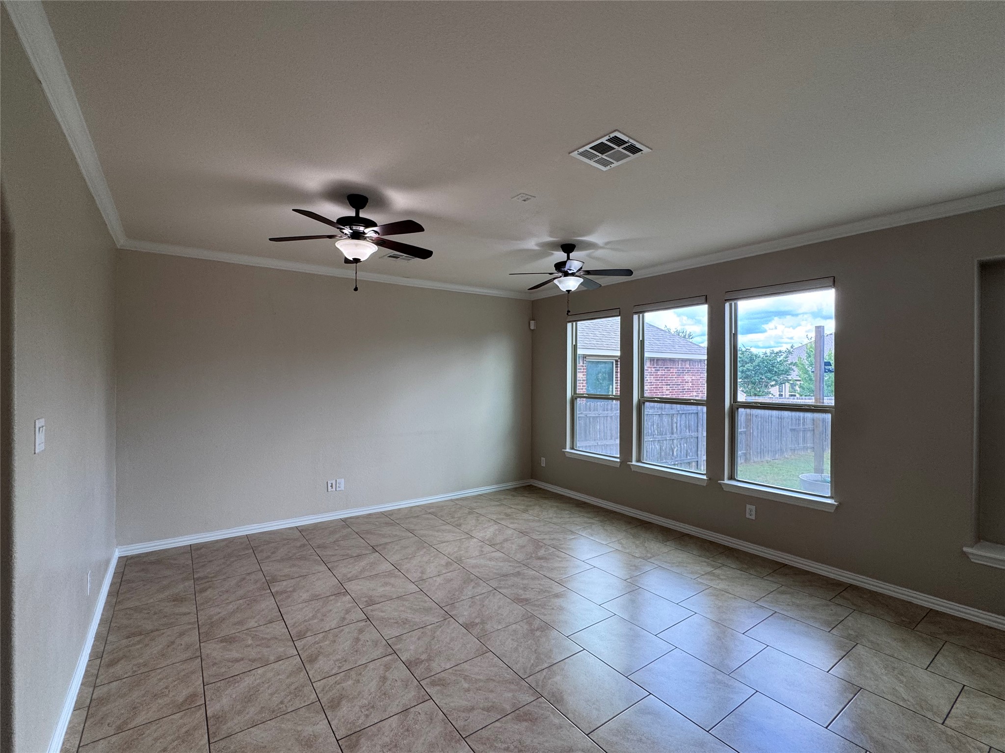 2605 Rough Berry Road Pflugerville, TX 78660 - Photo 9 of 40 A generous living area presents tiled flooring and an inviting view of the yard through multiple windows.