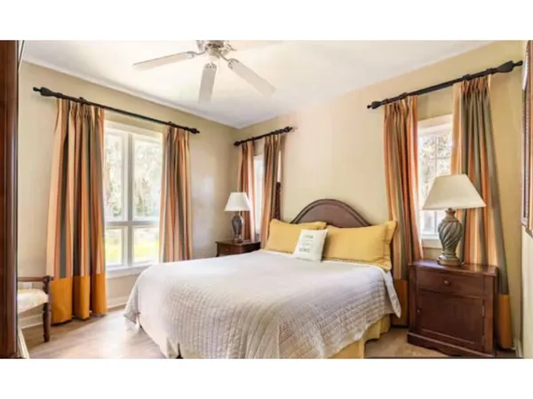 a bedroom with a large bed and a chandelier