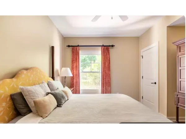 a bedroom with a bed and a large window