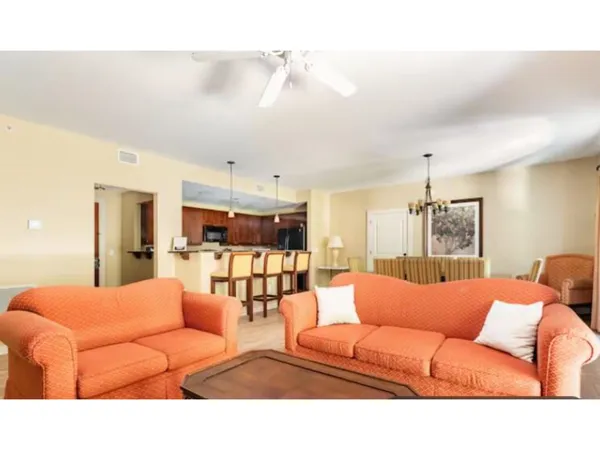 a living room with furniture and kitchen view