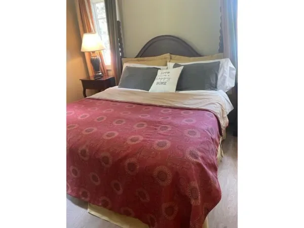 a bedroom with a bed and a window