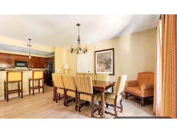 a living room with furniture a rug and a painting