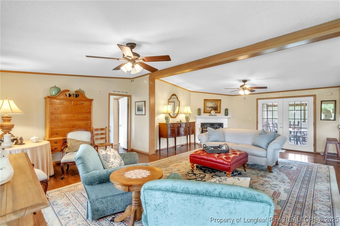 2185 Calloway Road Raeford, NC 28376 - Photo 11 of 49 a living room with furniture a rug and a chandelier