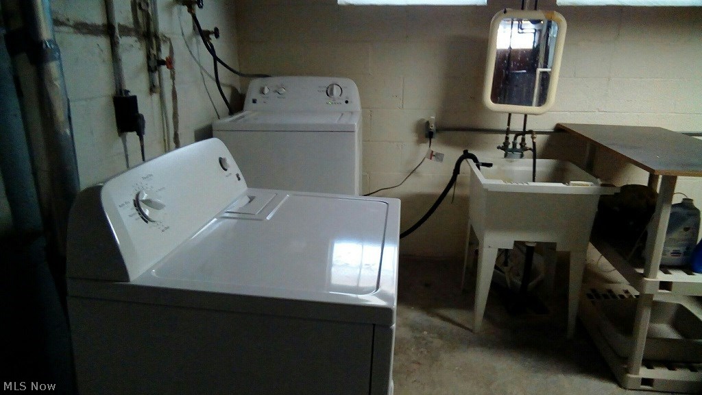 15712 Turney Road Maple Heights, OH 44137 - Photo 16 of 19 Laundry area in the basement. Newer washer, newer dryer, and a utility tub.