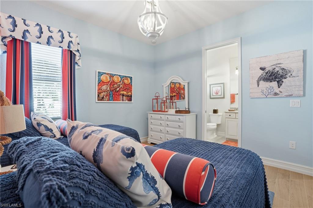 9923 Corso Bello Drive Naples, FL 34113 - Photo 25 of 47 a bed room with a bed and a painting on the wall