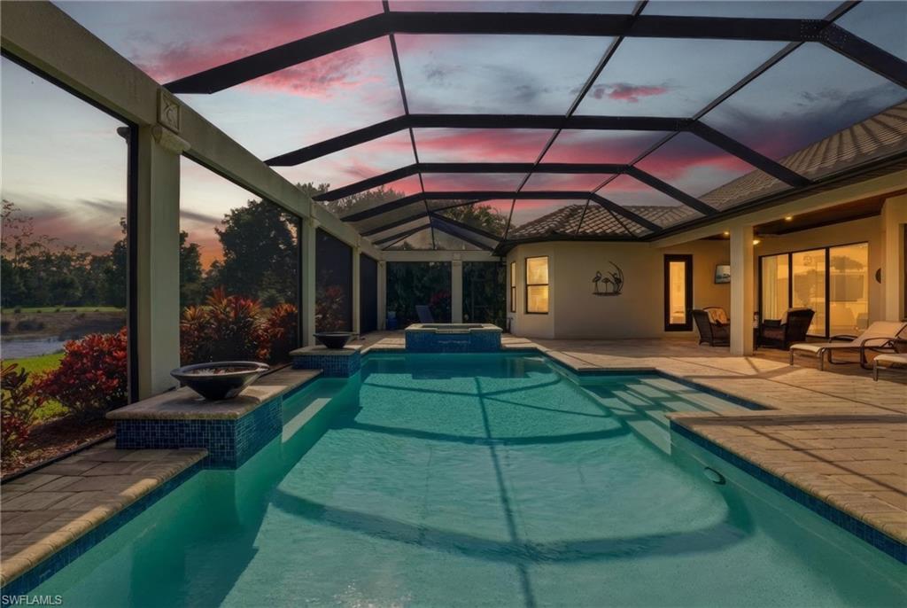 9923 Corso Bello Drive Naples, FL 34113 - Photo 31 of 47 a patio with a yard table and chairs