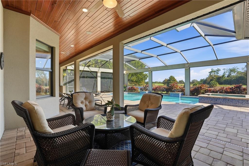 9923 Corso Bello Drive Naples, FL 34113 - Photo 32 of 47 a balcony with furniture and a garden