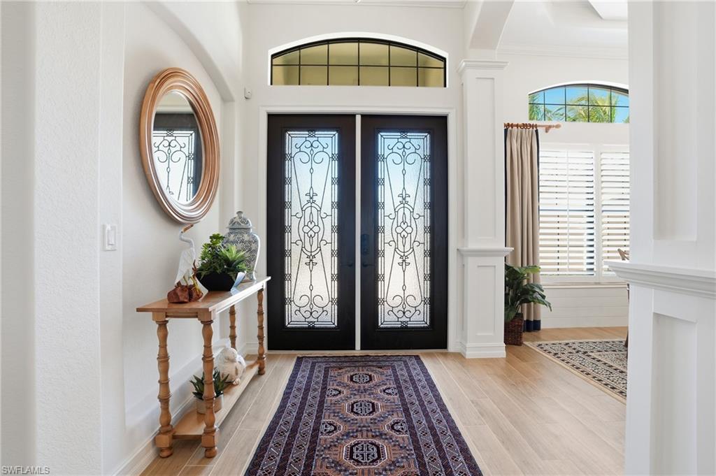 9923 Corso Bello Drive Naples, FL 34113 - Photo 6 of 47 a front view of a house with garden