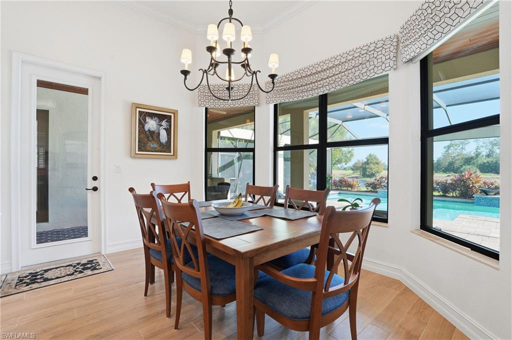 9923 Corso Bello Drive Naples, FL 34113 - Photo 8 of 47 a view of a dining room with furniture window and outside view