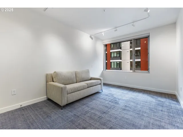 a living room with furniture and a ceiling fan