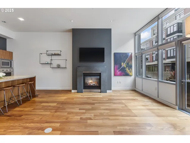 a view of an empty room with furniture and a fireplace