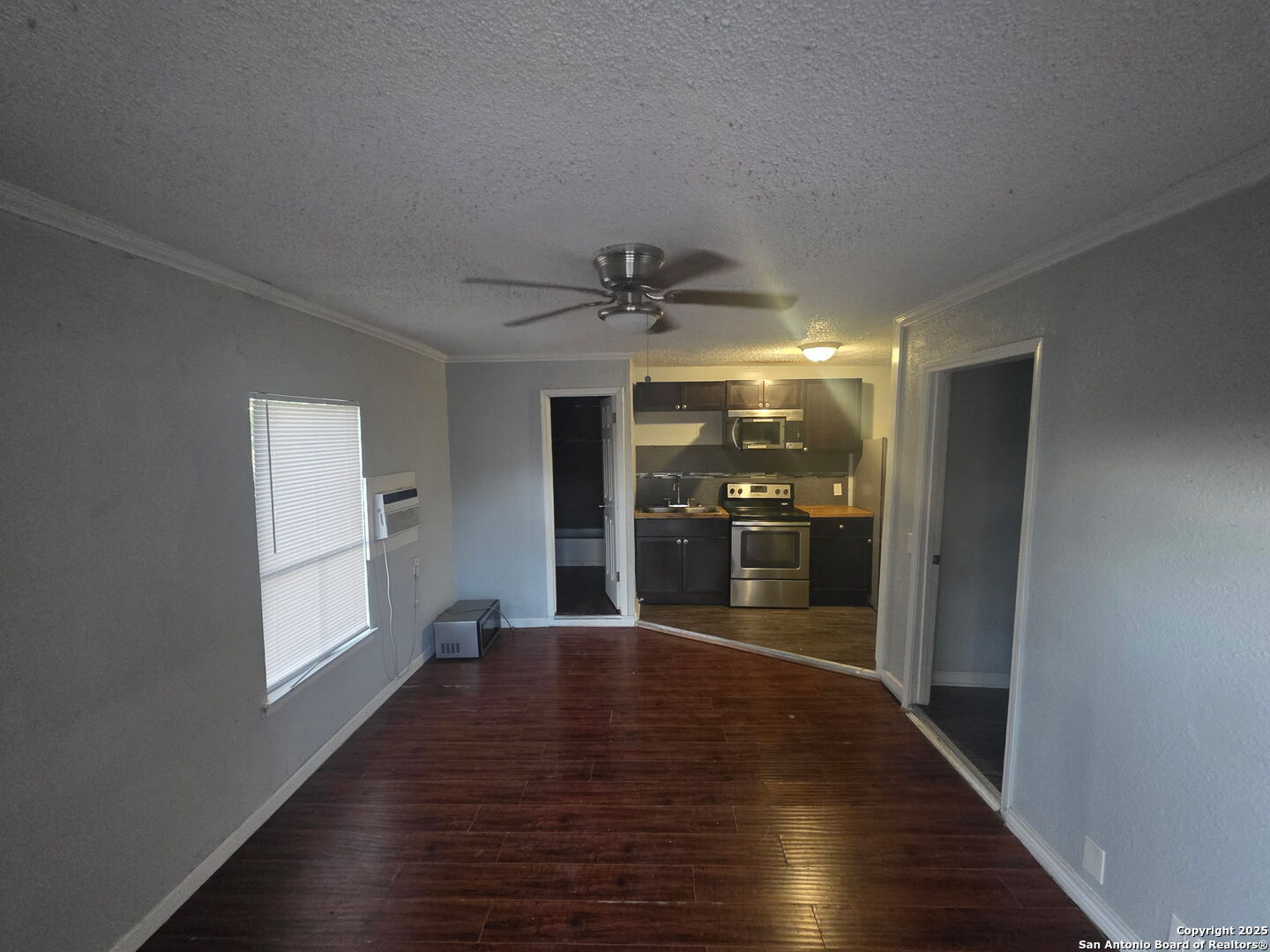 1431 Cantrell Drive, Unit 4 San Antonio, TX 78221 - Photo 5 of 5 a view of a hallway with wooden floor and a kitchen