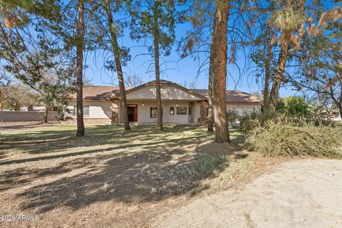 a front view of a house with a yard covered with snow