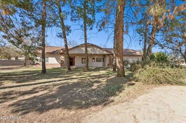 a front view of a house with a yard covered with snow