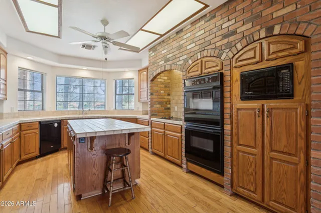 a kitchen with a refrigerator stove and wooden cabinets