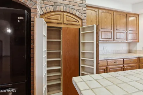 a view of a kitchen with cabinets and wooden floor