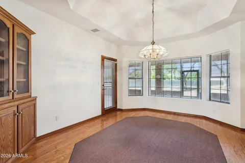 a view of a livingroom with furniture wooden floor and a chandelier