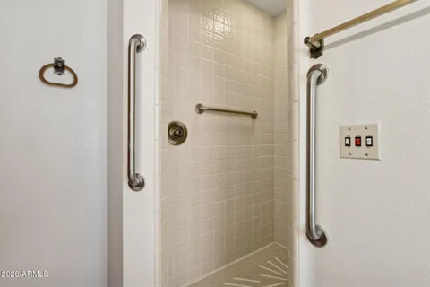 an empty room with windows and ceiling fan