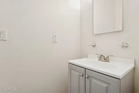 a view of a white house with a yard covered in snow