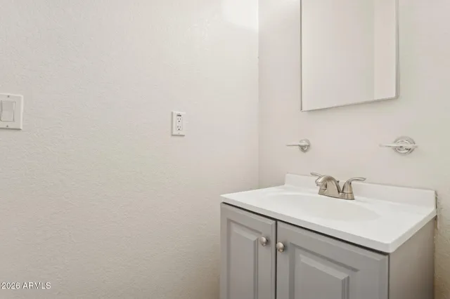 a view of a white house with a yard covered in snow