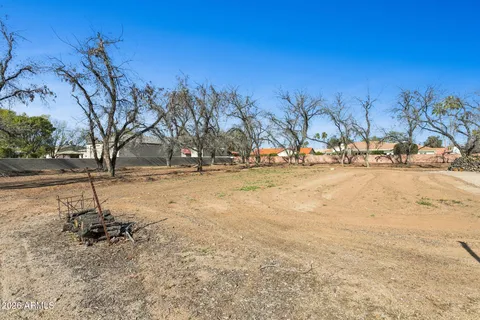 an aerial view of a house with a yard and lake view