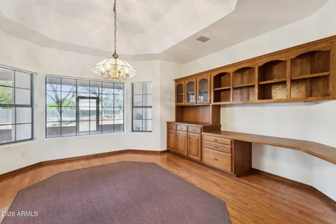 a kitchen with stainless steel appliances granite countertop a refrigerator a stove and a wooden floors