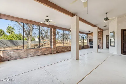 a living room with stainless steel appliances kitchen island granite countertop a stove a sink and cabinets