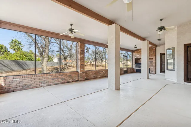 a living room with stainless steel appliances kitchen island granite countertop a stove a sink and cabinets